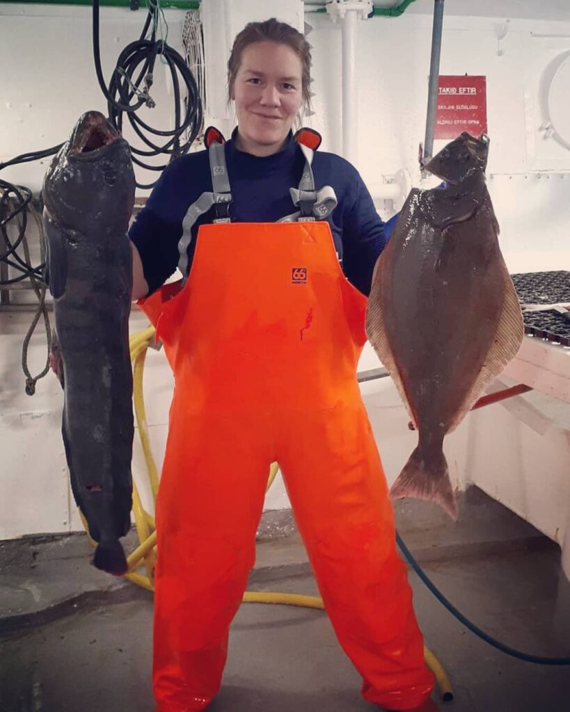 Hrönn Egilsdóttir holding a wolfish and a halibut
